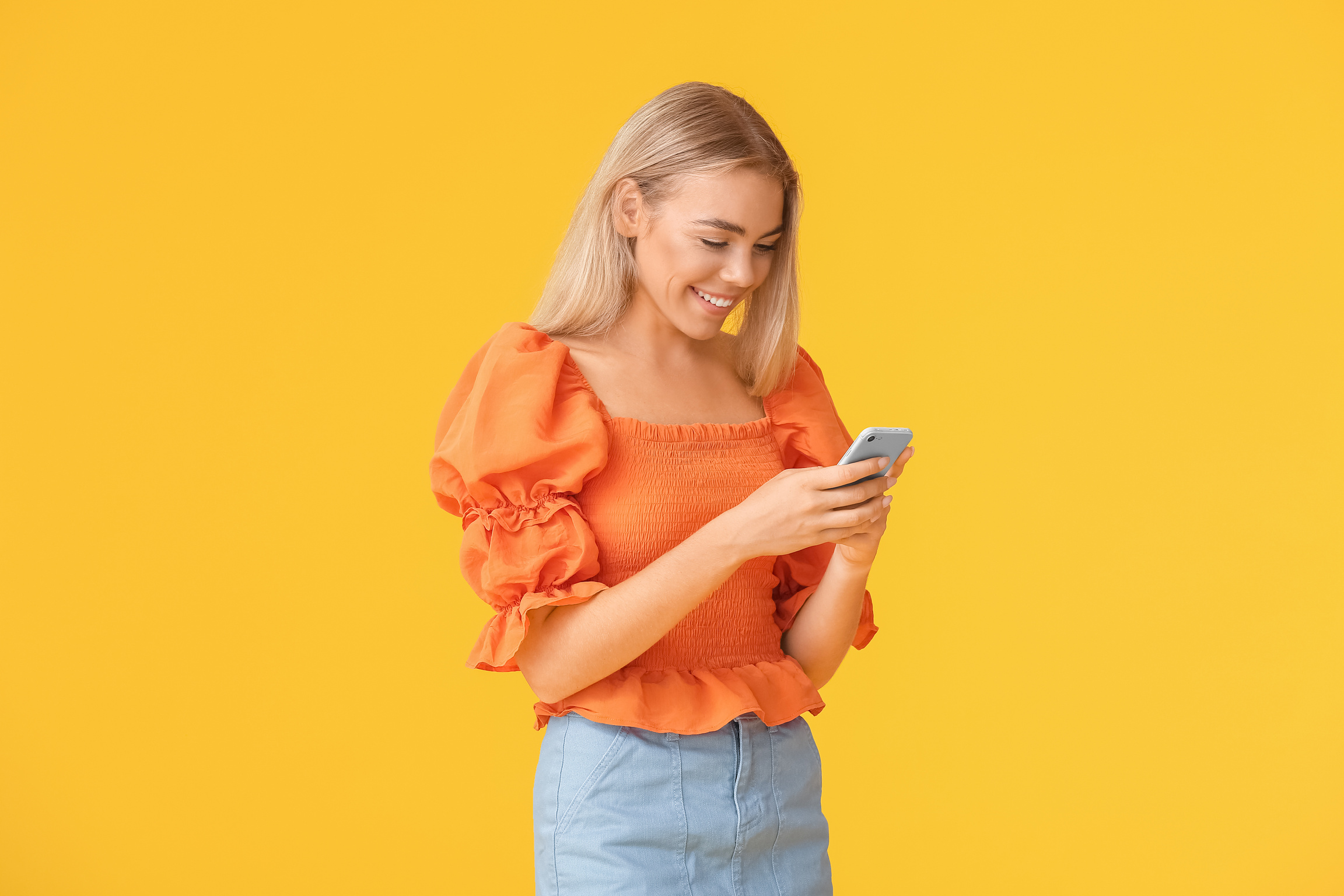 Teenage Girl with Mobile Phone on Color Background
